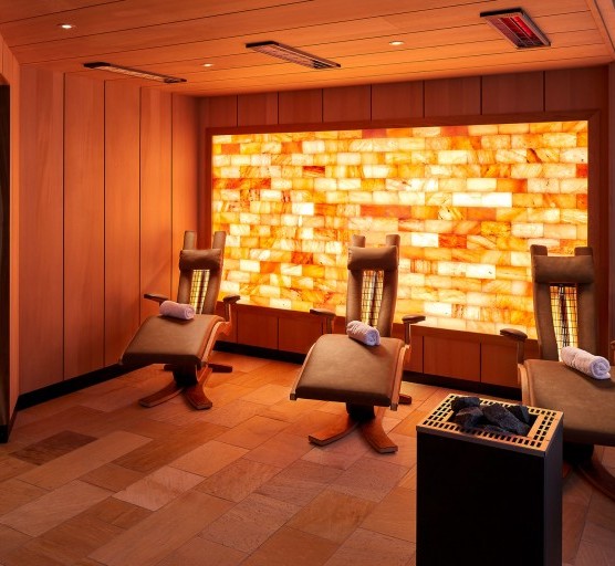 Infrared sauna with loungers and atmospheric lighting.